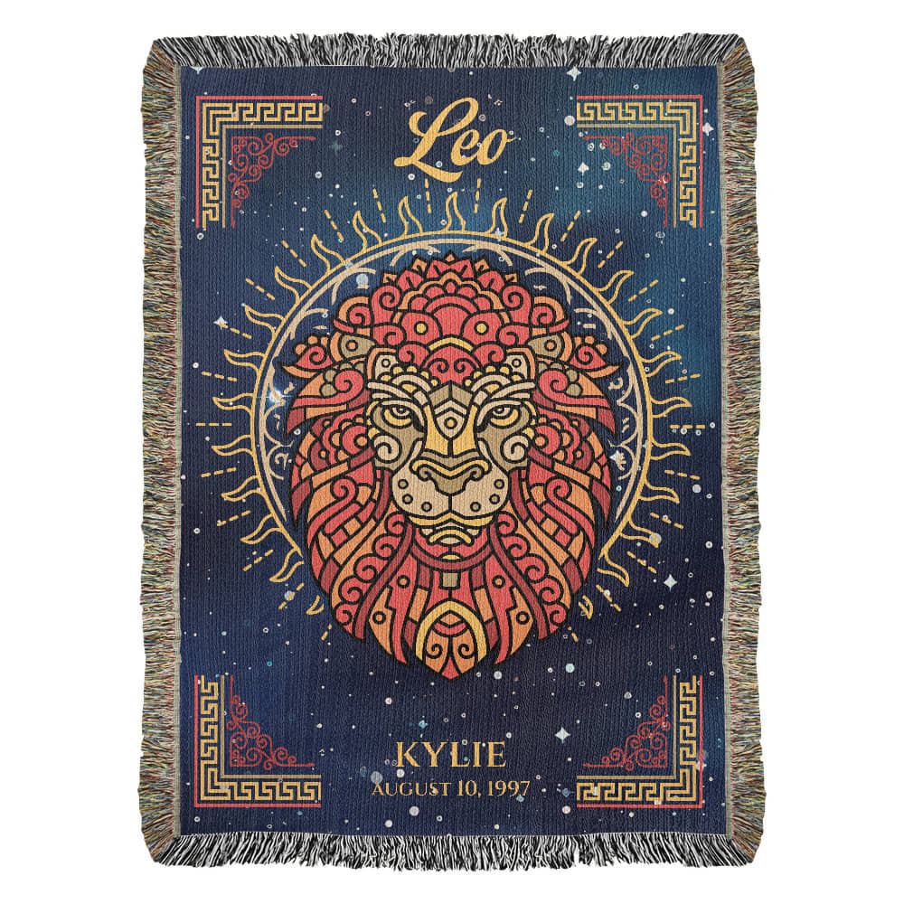 A personalized woven blanket with a Leo zodiac sign design, featuring a lion's face with ornate patterns and the name 'Kylie' along with the date 'August 10, 1992' on it. The blanket has a blue background with a decorative border.