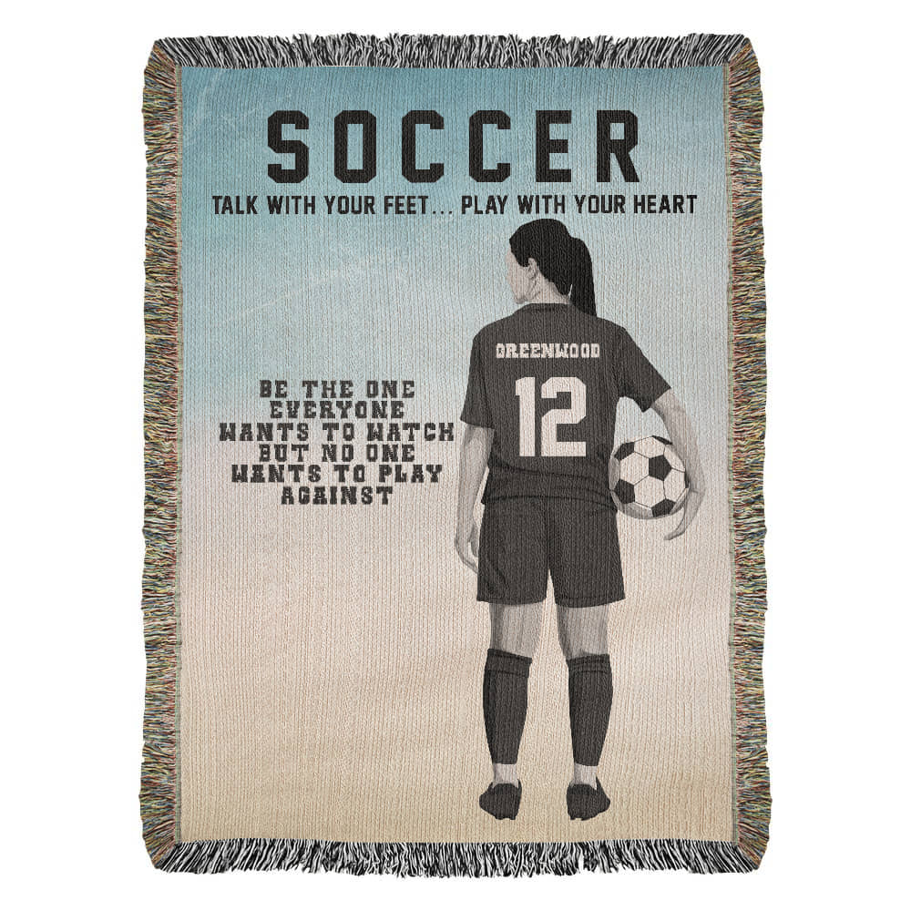 A woven blanket with a soccer theme, featuring a player holding a soccer ball and the text 'SOCCER', along with motivational quotes.