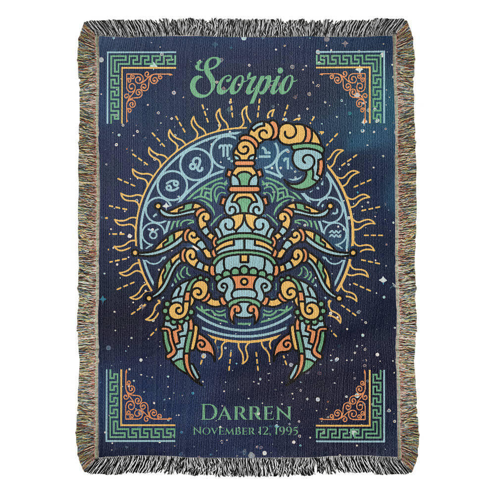 A woven blanket with a Scorpio zodiac sign design, predominantly in dark colors with a colorful fringe, and personalized text that includes a name and dates.