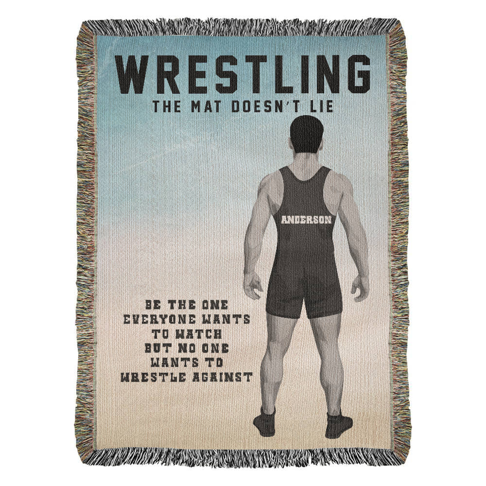 Woven blanket with a wrestling theme, featuring a rear-view of a wrestler in a singlet with text on the back, and the text 'WRESTLING THE MAT DOESN'T LIE' at the top.