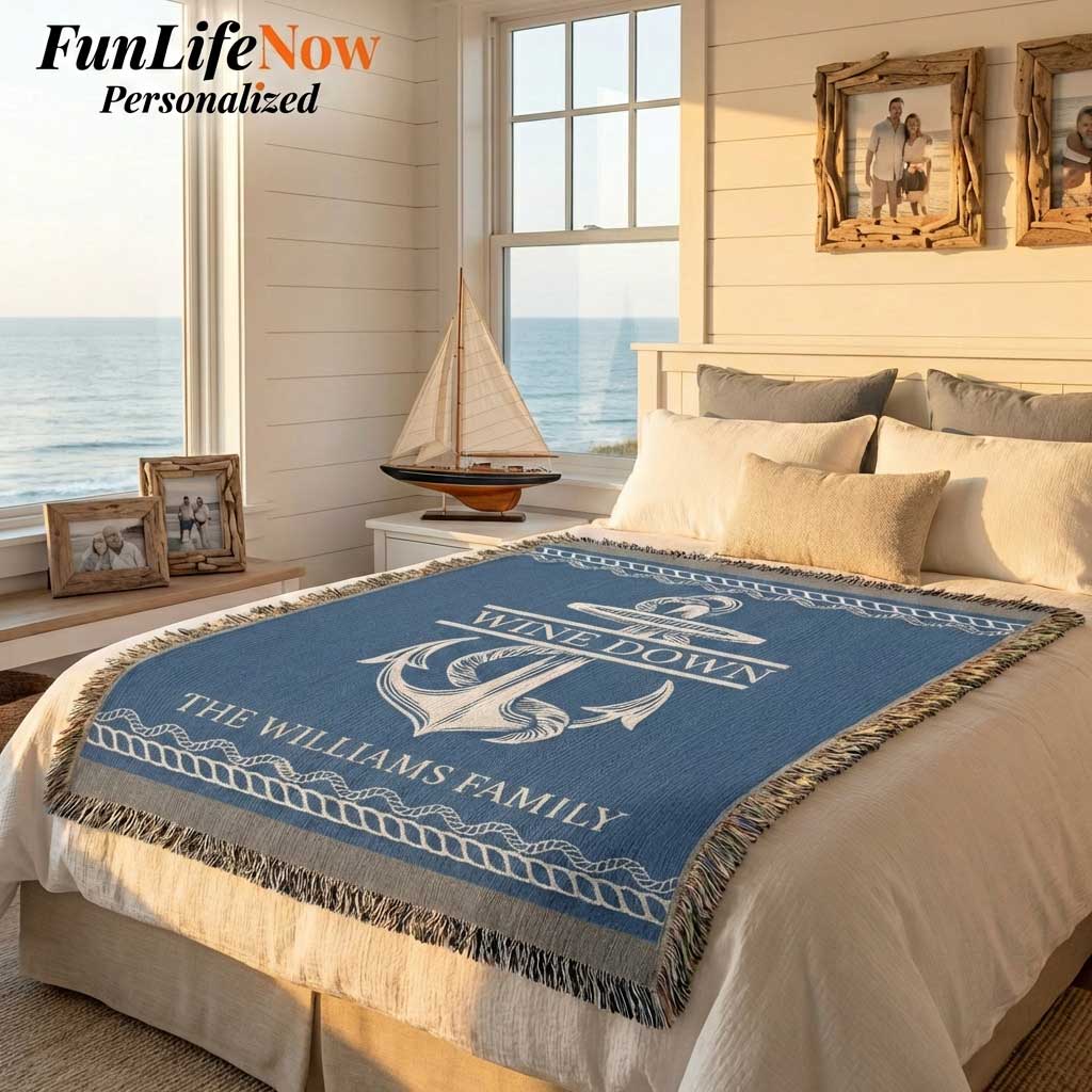 Bedroom with a personalized nautical blanket featuring an anchor design and personalized text, with a view of the ocean through a window. Custom blanket available at funlifenow.com