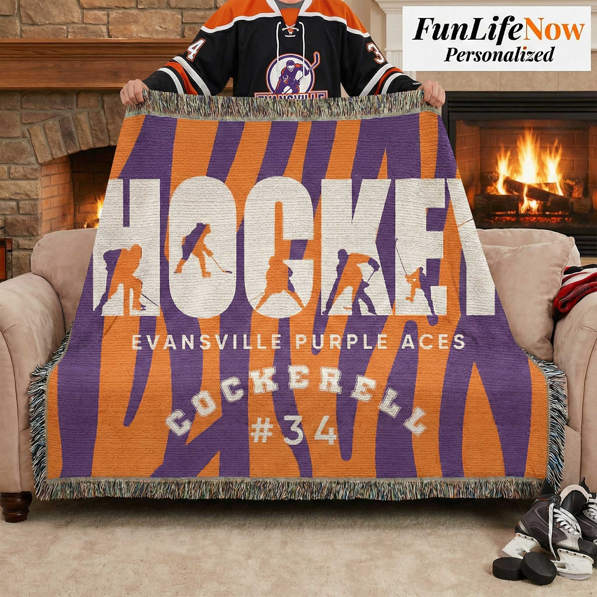 Person holding a hockey-themed blanket with 'Evansville Purple Aces' text in a cozy living room.