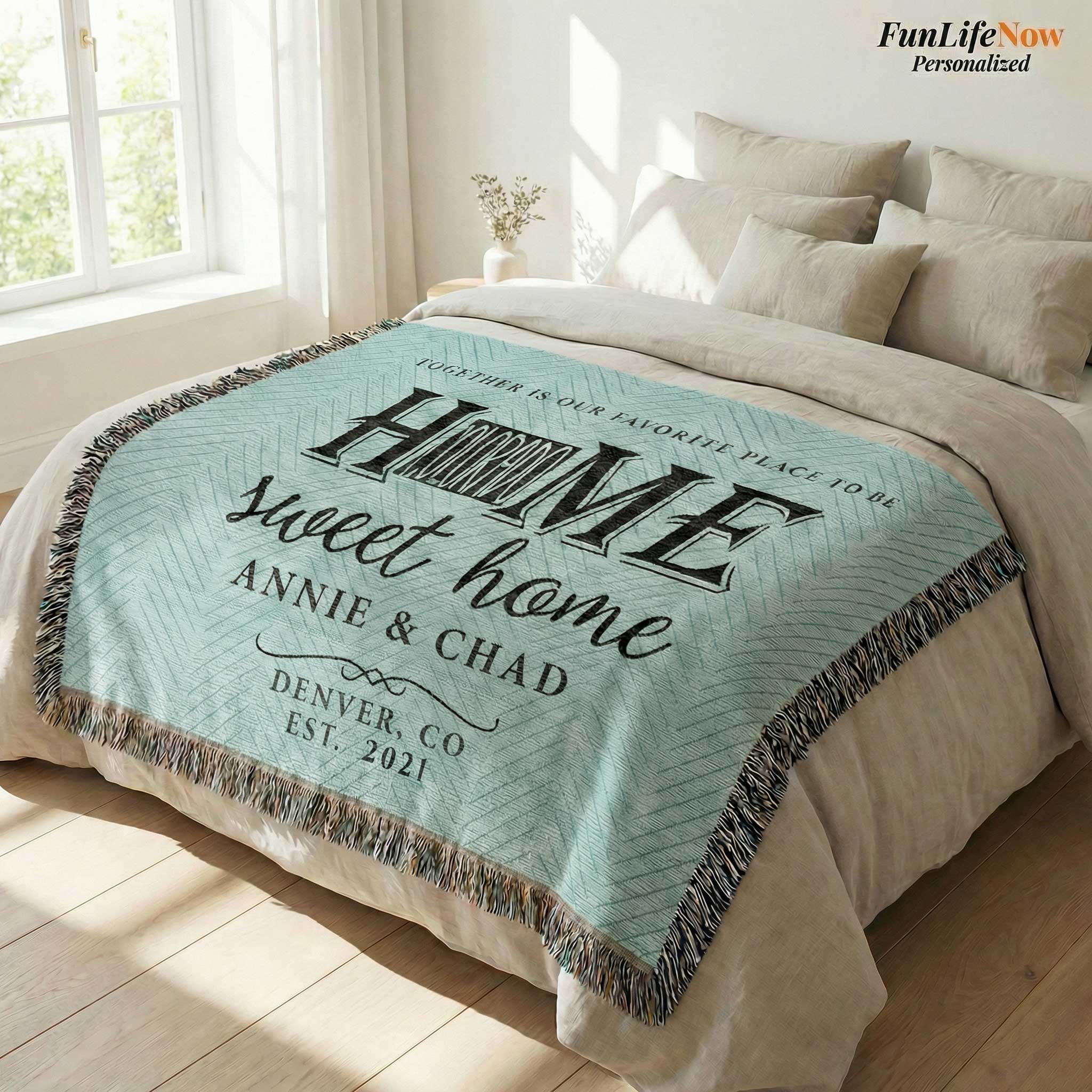 Personalized blanket with 'Home sweet home' text on a couch in a living room.