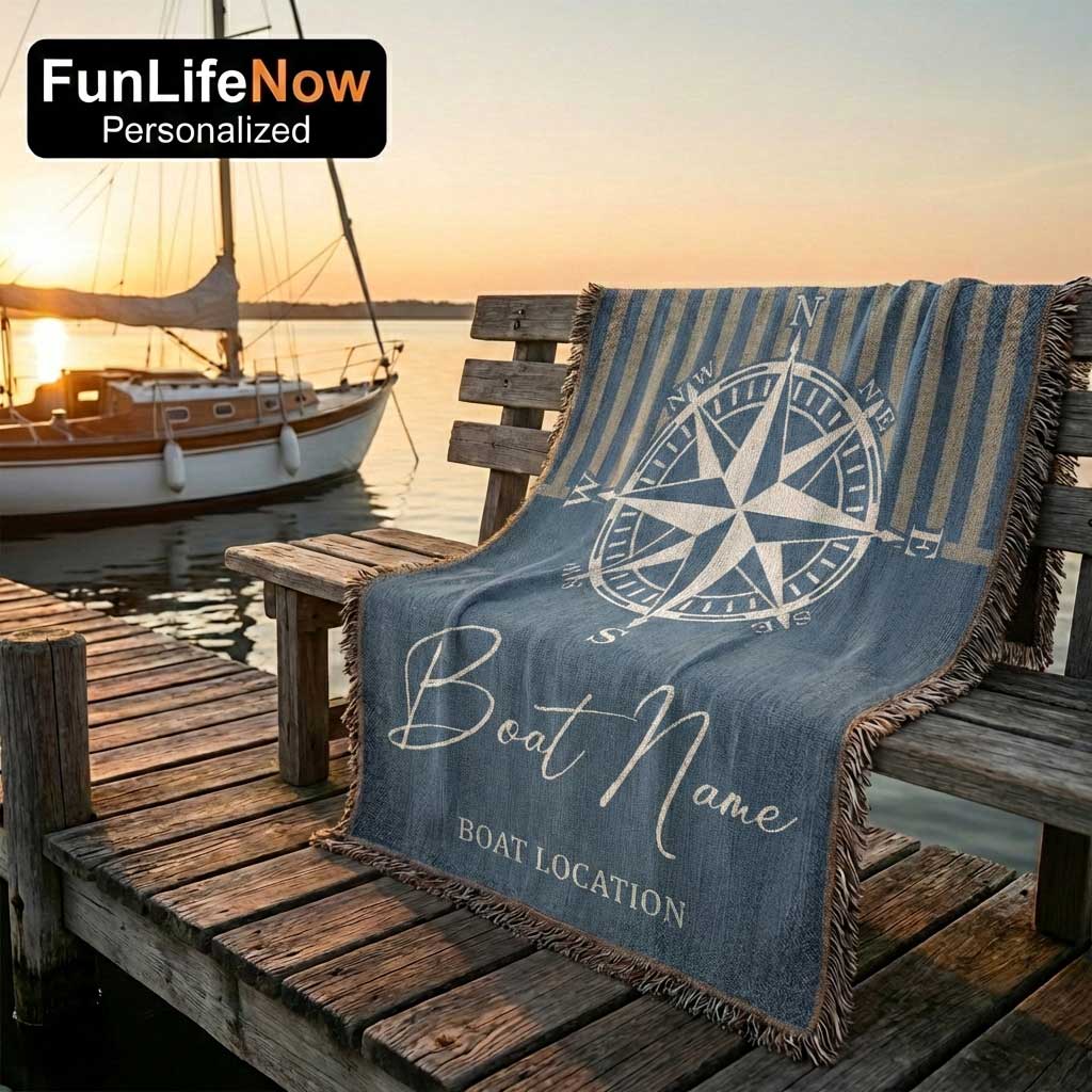 Nautical-themed personalized blanket with compass design and customizable text on a wooden bench by a dock. Custom blanket available at funlifenow.com