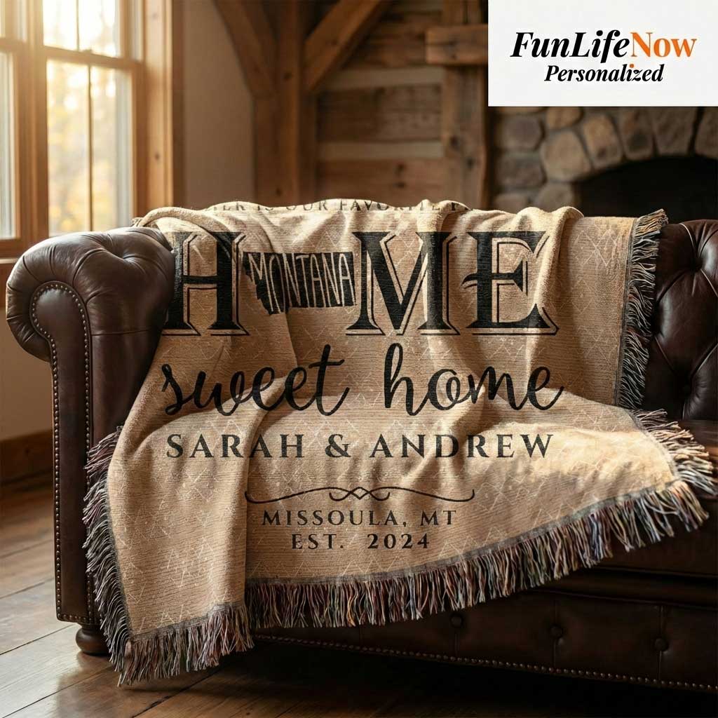 Personalized Montana blanket with 'Home sweet home' text on a brown leather couch in a cozy room. Blanket available at funlifenow.com