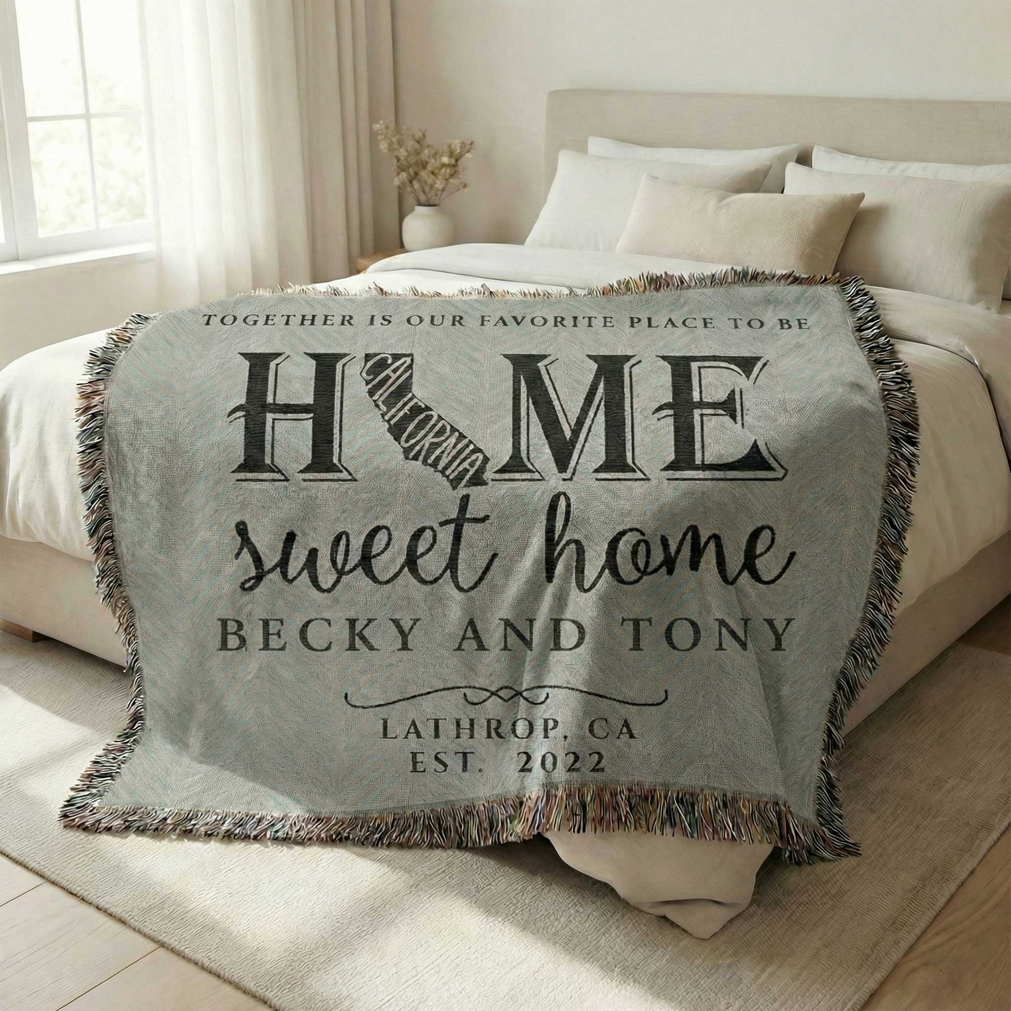 Personalized 'Home sweet home' California State blanket on a bed in a bedroom. Custom blanket available at funlifenow.com