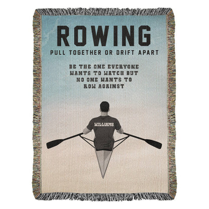 A personalized woven blanket with a rowing theme, featuring a silhouette of a rower and the text 'ROWING PULL TOGETHER OR DRIFT APART BE THE ONE EVERYONE WANTS TO WATCH BUT NO ONE WANTS TO ROW AGAINST' along with the name 'WILLIAMS' on the back. Name on back of jersey is customizable. 