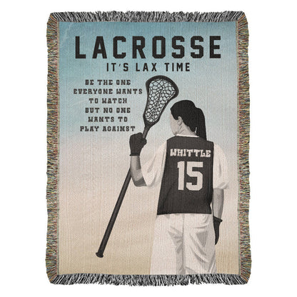 A personalized woven blanket with a graphic of a girls lacrosse player in action and the text 'LACROSSE IT'S LAX TIME' along with the quote \"Be the one everyone wants to watch but no one wants to play against. The name and jersey number are customizable.