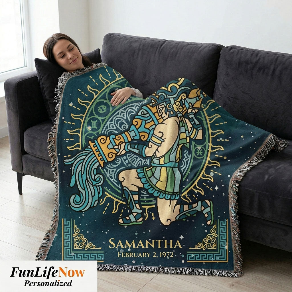 Person lying on a couch with a personalized blanket featuring a design and name.