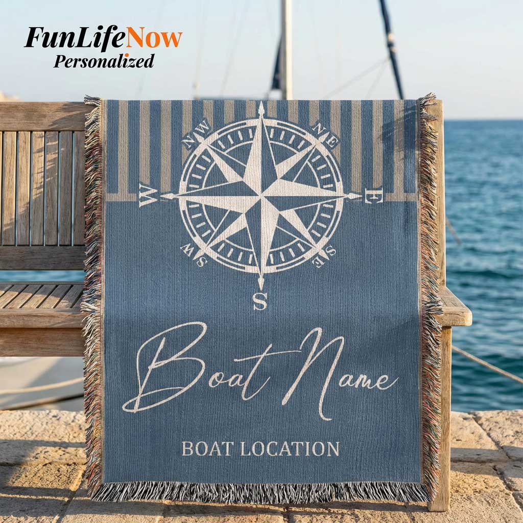Nautical-themed personalized blanket with compass design and customizable text, placed on a wooden chair by the water. Custom blanket available at funlifenow.com