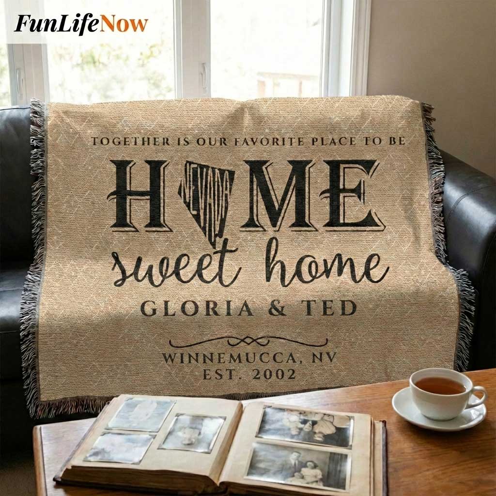 Personalized Nevada State 'Home Sweet Home' blanket on a couch with a coffee cup and photo album.