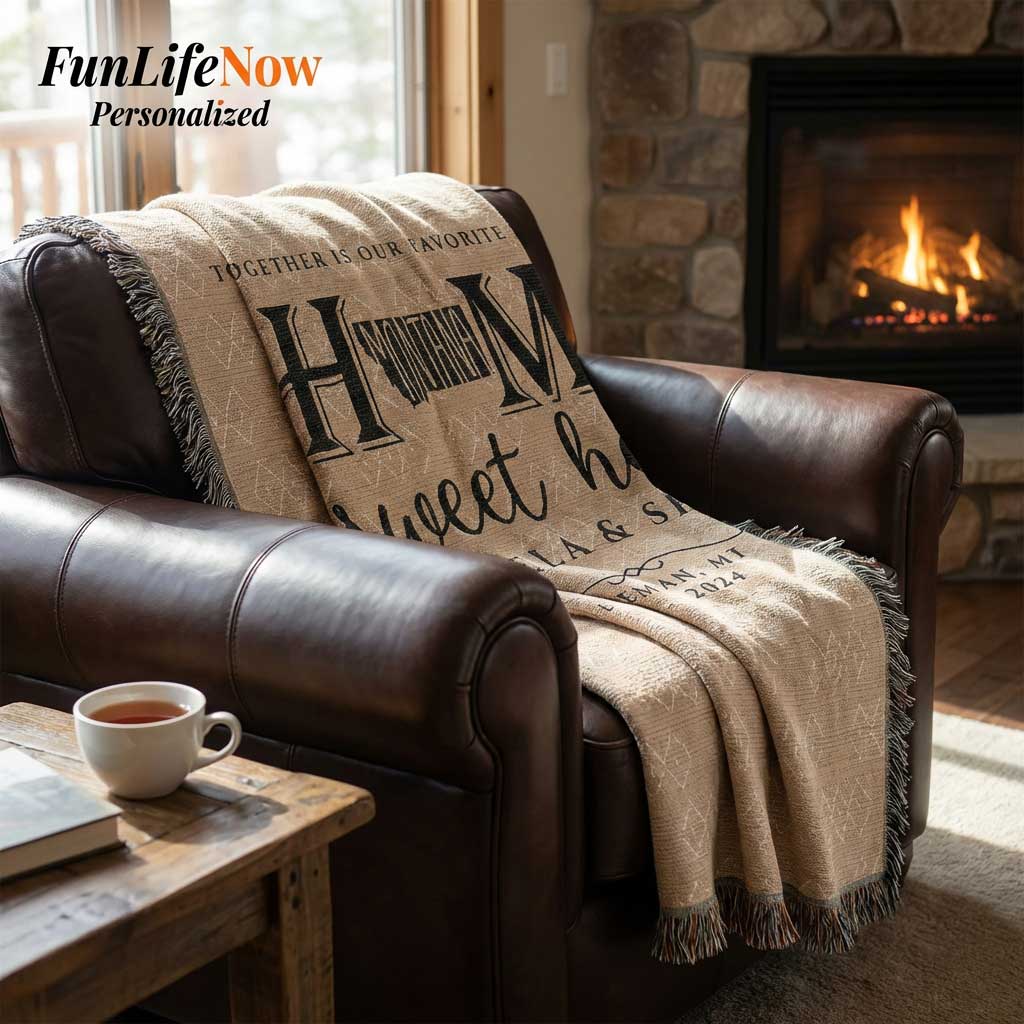 Beige blanket with Montana personalized text draped over a brown leather sofa in front of a fireplace, with 'FunLifeNow' branding.