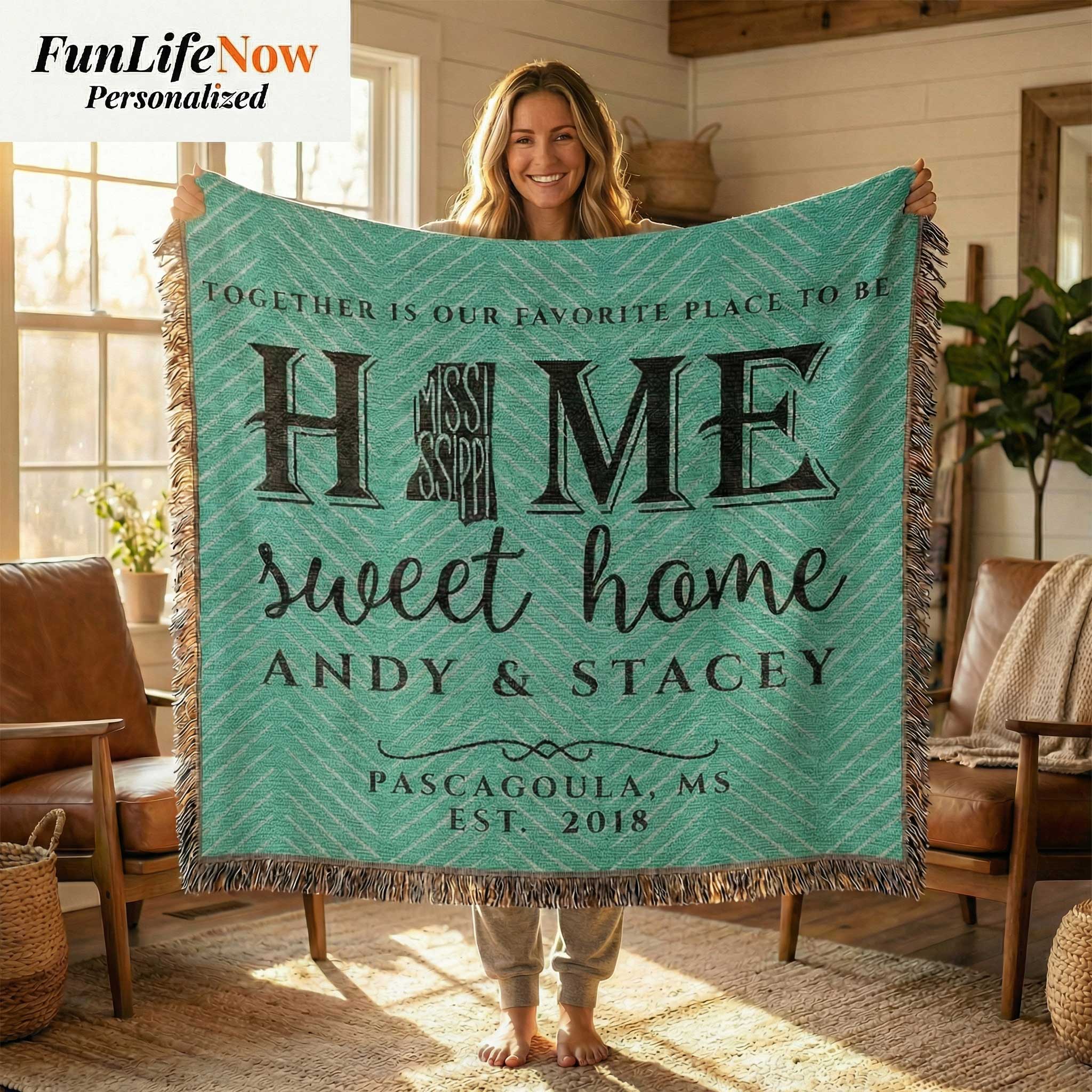 Woman holding a personalized blanket with 'Home sweet home' text in a cozy living room. Personalized Mississippi blanket available at funlifenow.com