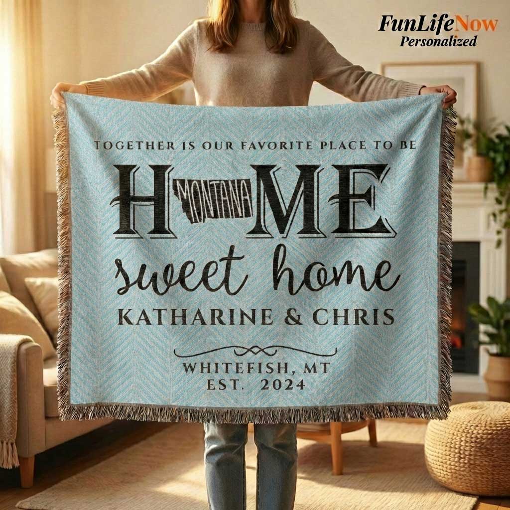 Person holding a personalized Montana blanket with 'Home sweet home' text and names in a cozy living room. Blanket available at funlifenow.com
