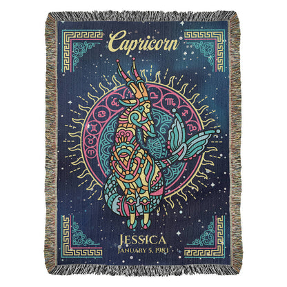 A personalized woven blanket with a Capricorn zodiac sign design, featuring a goat, and personalized text including a name and dates.