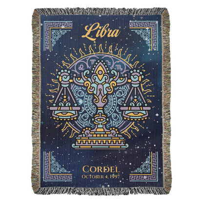 A Personalized woven blanket with a Libra zodiac sign design, featuring scales and stars in a dark blue background with colorful fringe.