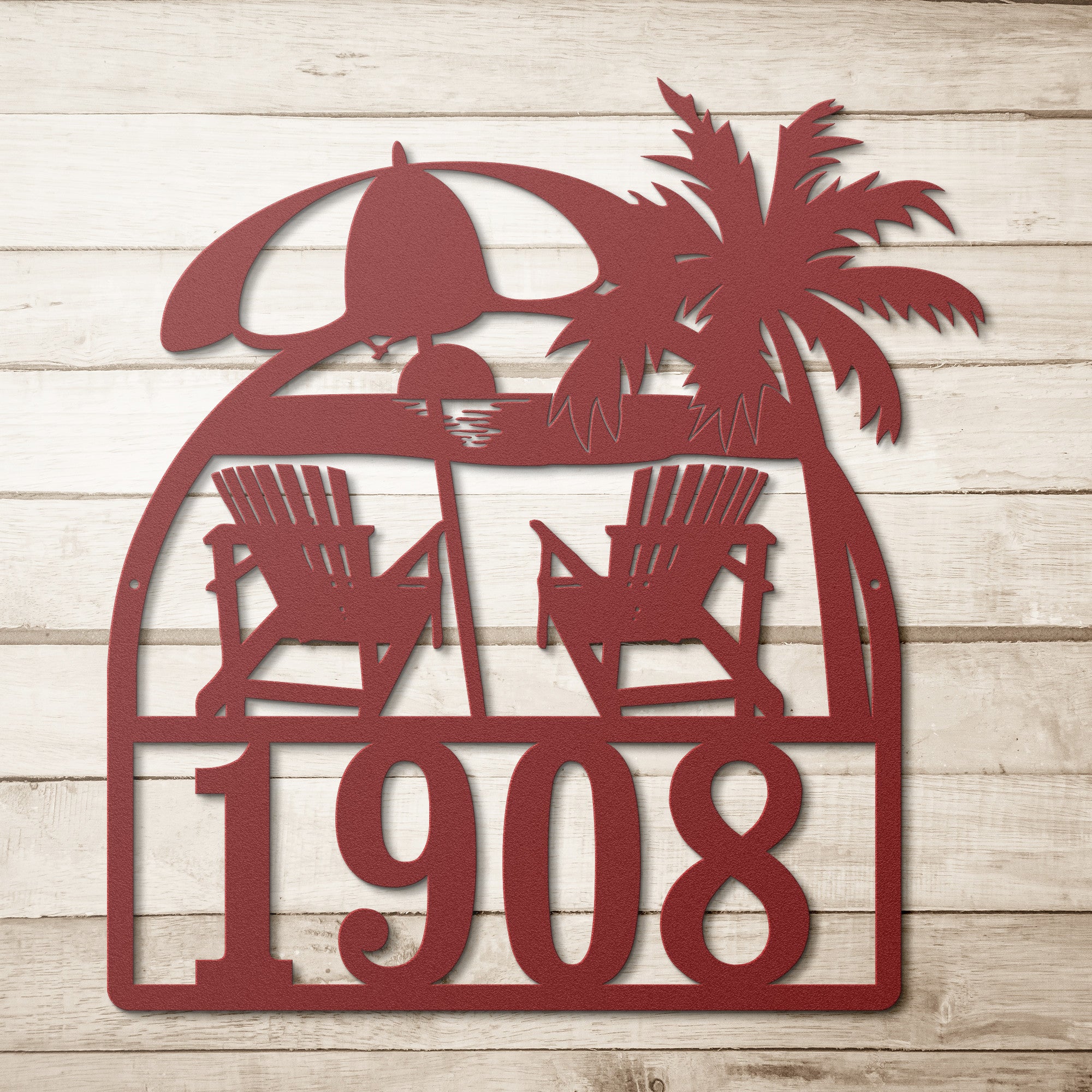 A metal decor sign featuring two beach chairs and a palm tree with the customizable street numbers below.